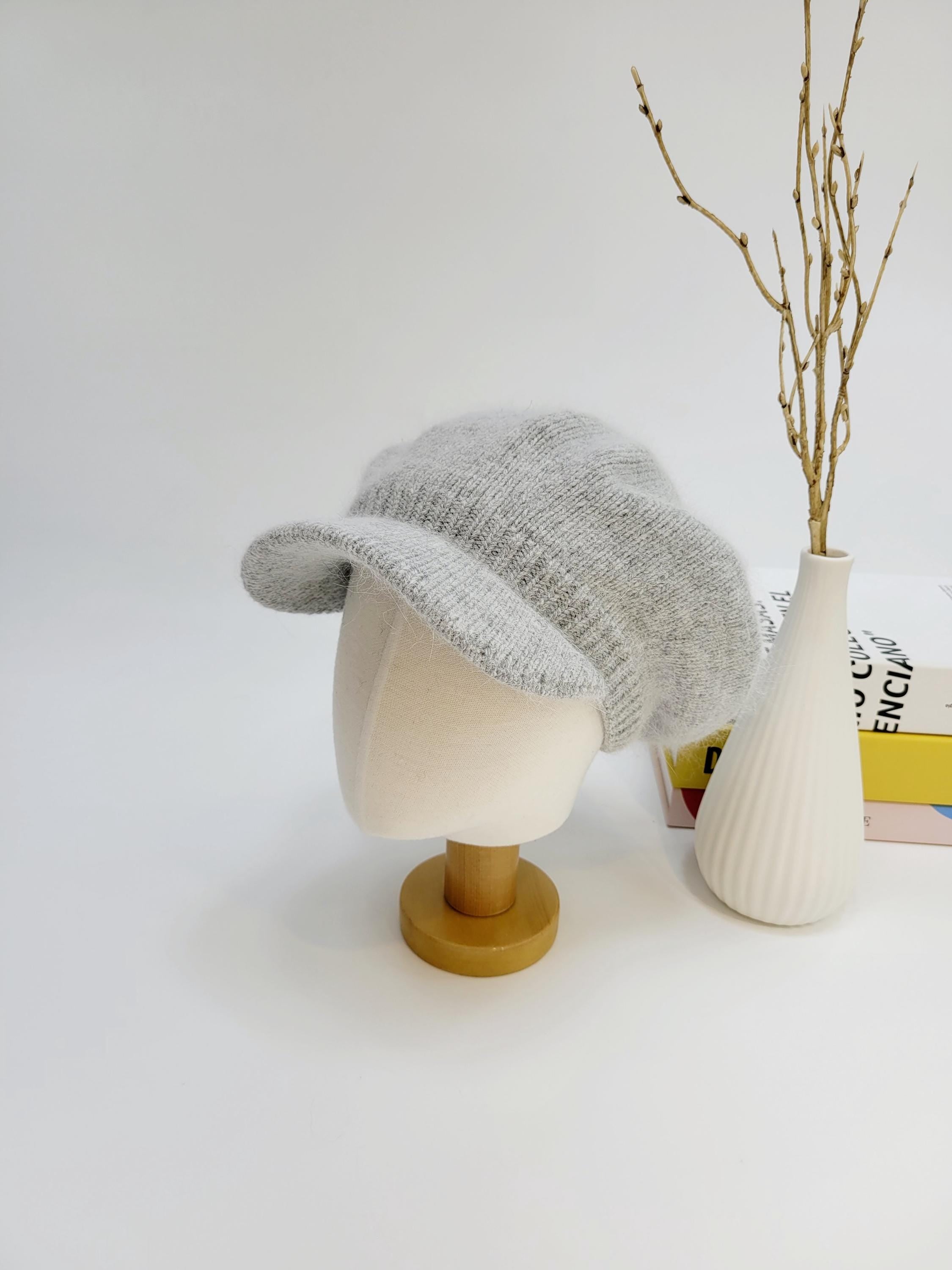 Light gray knit cap, the angelina in love, displayed on a mannequin head with a short brim.